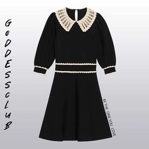 Black knit dress with white contrasting embroidery and puffy short sleeve